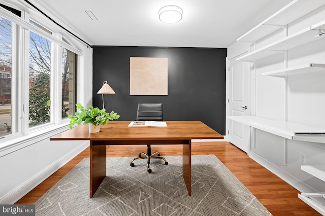 home office with hardwood / wood-style floors