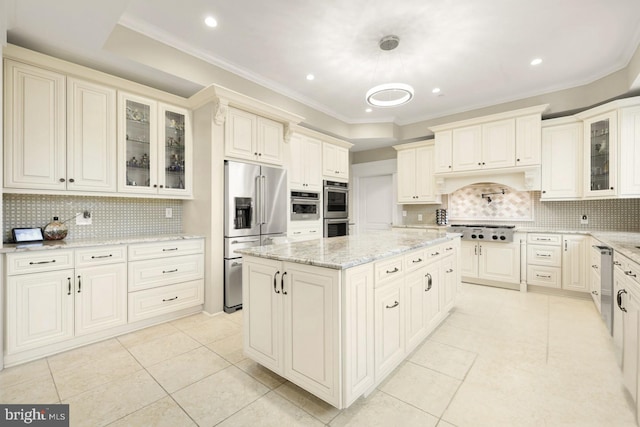 kitchen featuring light stone countertops, appliances with stainless steel finishes, tasteful backsplash, and hanging light fixtures