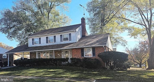 view of front of property featuring a carport and a front yard