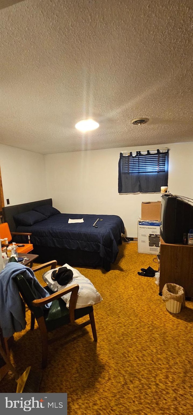 carpeted bedroom with a textured ceiling