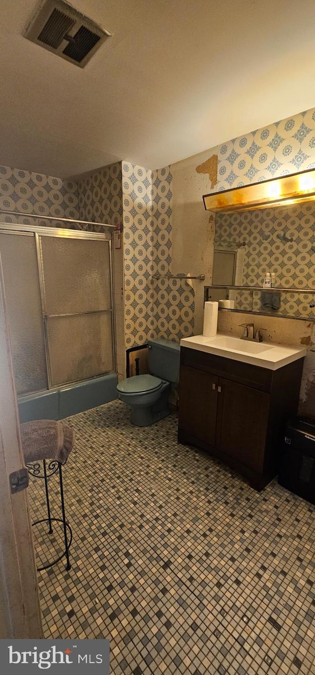 bathroom with tile patterned flooring, vanity, and toilet