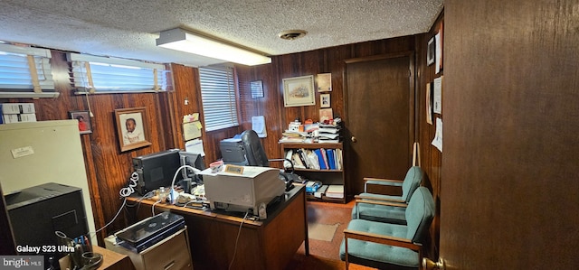 office area featuring wood walls and a textured ceiling