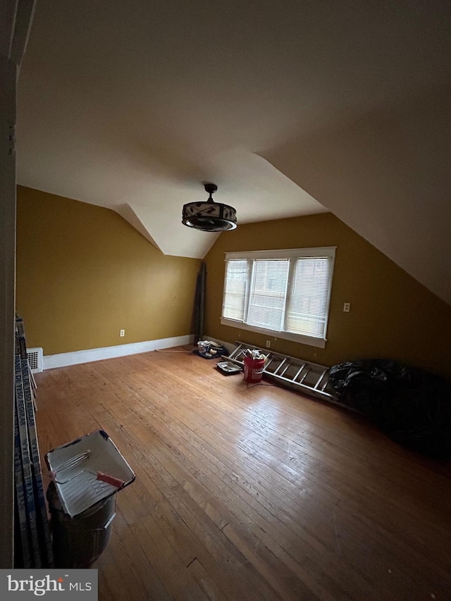 bonus room with hardwood / wood-style floors and lofted ceiling