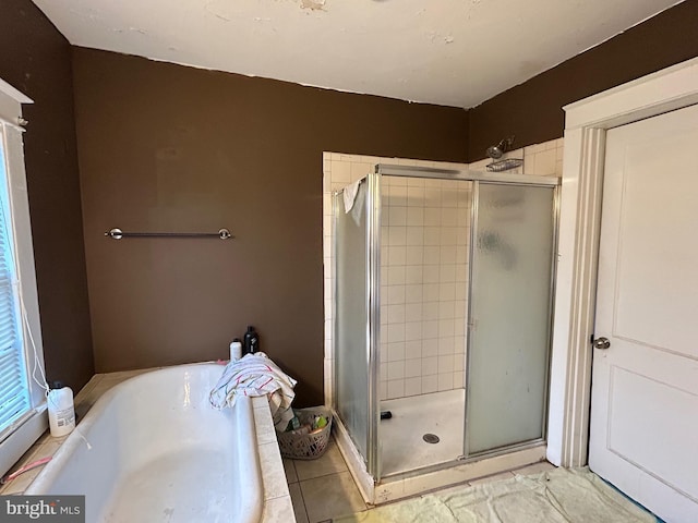 bathroom featuring tile patterned flooring and shower with separate bathtub