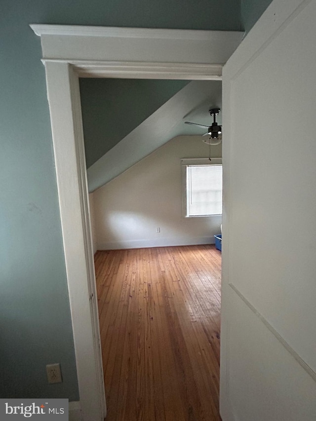 additional living space featuring ceiling fan, wood-type flooring, and vaulted ceiling