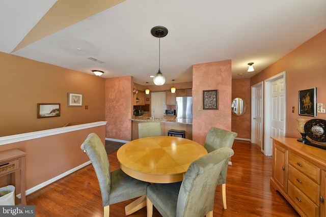 dining area with dark hardwood / wood-style floors