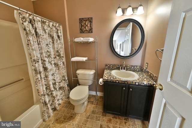 full bathroom featuring vanity, shower / bath combo with shower curtain, and toilet