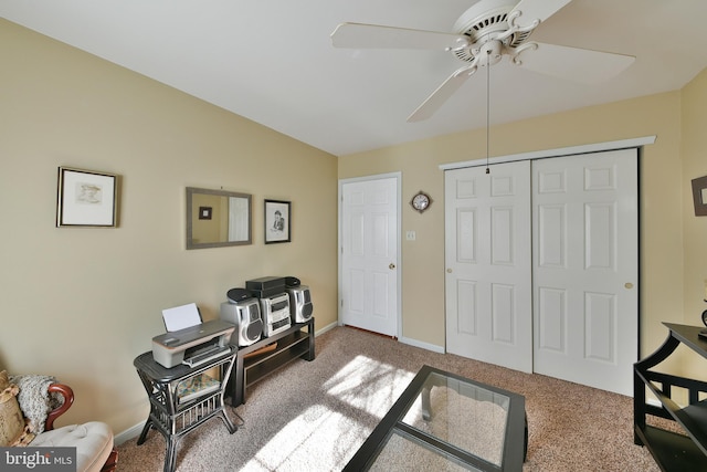 carpeted office featuring ceiling fan