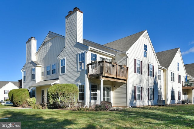 view of side of property featuring central AC unit and a yard