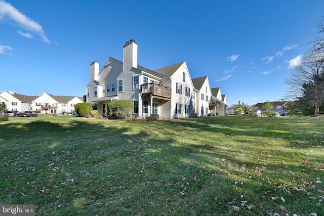 back of house featuring a lawn