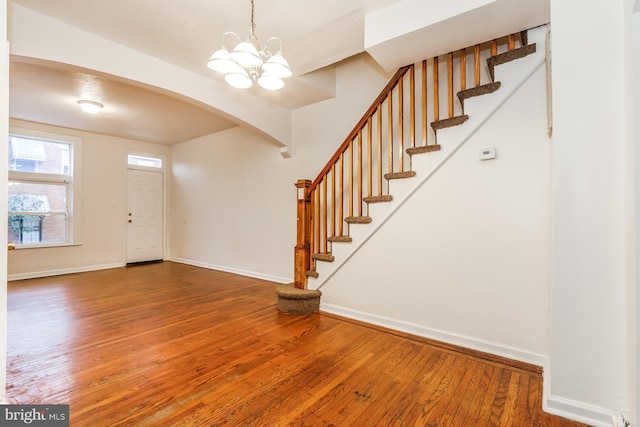 entrance foyer with wood-type flooring and an inviting chandelier