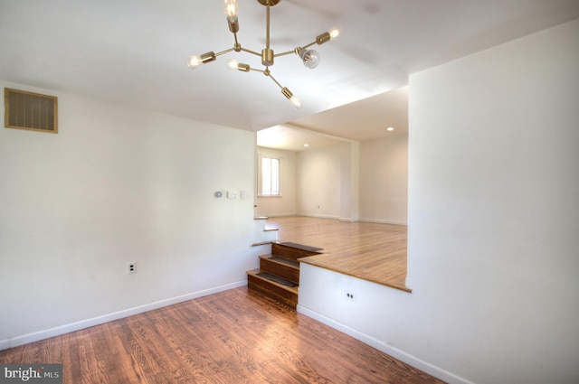 unfurnished room with wood-type flooring