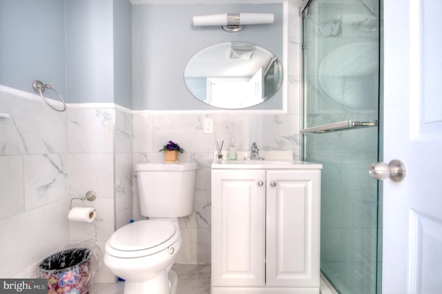 bathroom featuring vanity, toilet, an enclosed shower, and tile walls