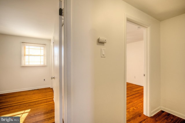 hallway with hardwood / wood-style floors