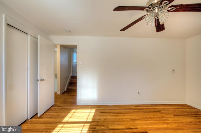 empty room featuring ceiling fan and light hardwood / wood-style flooring