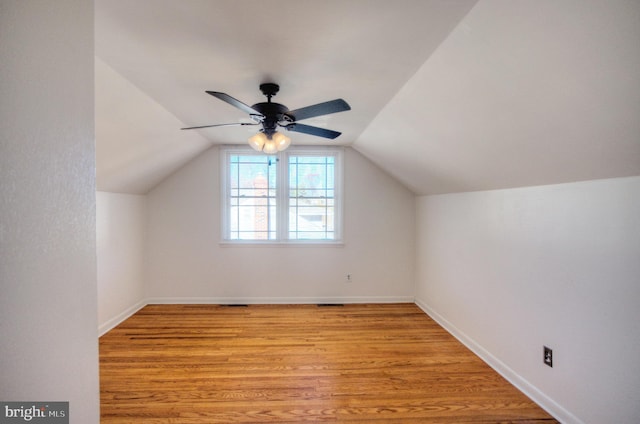 bonus room featuring ceiling fan, light wood-type flooring, and vaulted ceiling