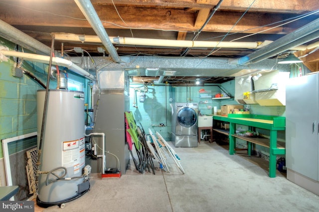 basement featuring water heater, sink, and washer / dryer