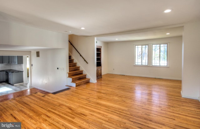 unfurnished living room with light wood-type flooring