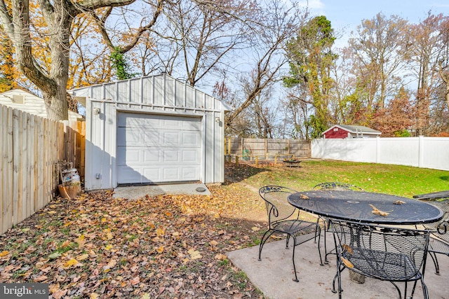 view of yard with a garage and an outdoor structure