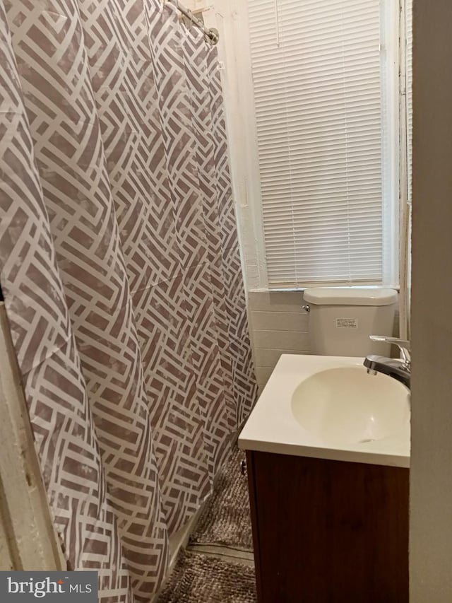 bathroom featuring vanity and toilet