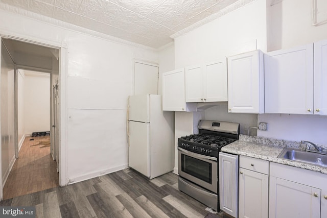 kitchen featuring white cabinetry, sink, dark wood-type flooring, white refrigerator, and stainless steel gas stove