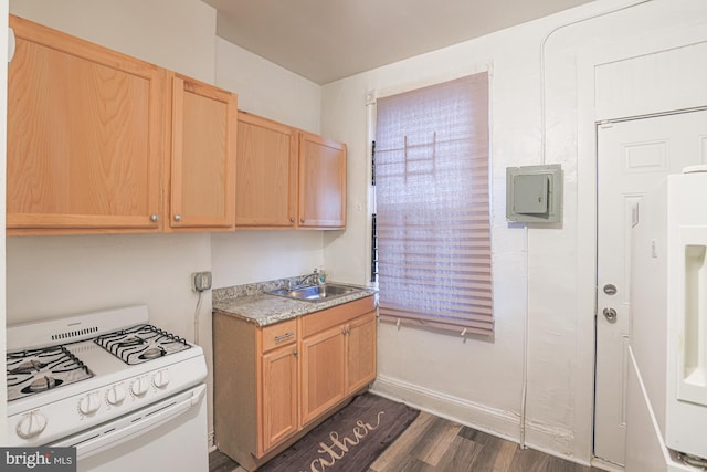 kitchen with light brown cabinets, white gas range, sink, and dark hardwood / wood-style flooring