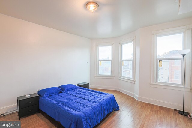 bedroom with wood-type flooring