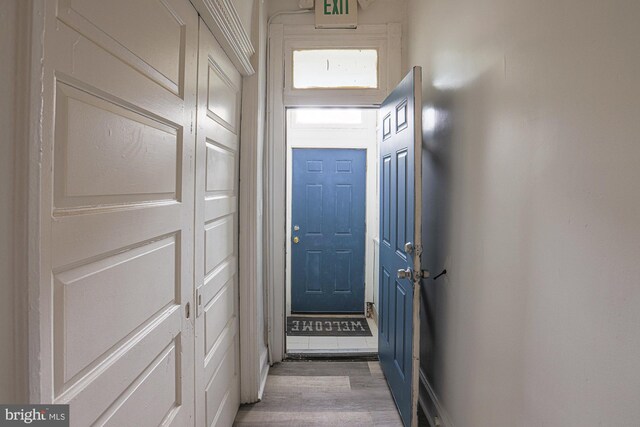 doorway with hardwood / wood-style flooring