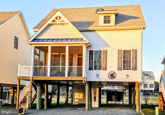 view of front facade with a sunroom and a carport