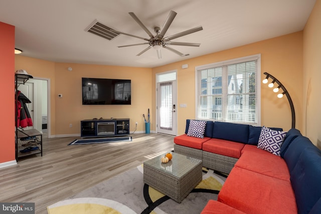 living room with light hardwood / wood-style floors and ceiling fan