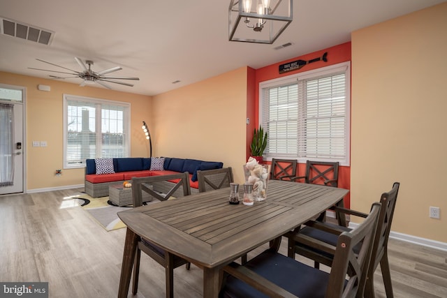 dining room with ceiling fan and light hardwood / wood-style flooring