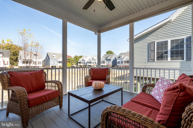 sunroom featuring ceiling fan and wooden ceiling