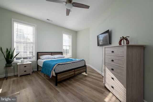 bedroom with hardwood / wood-style flooring and ceiling fan