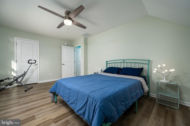 bedroom featuring ceiling fan, hardwood / wood-style floors, and lofted ceiling