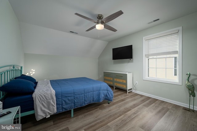 bedroom with light wood-type flooring, ceiling fan, and lofted ceiling