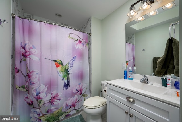 bathroom with tile patterned flooring, vanity, toilet, and curtained shower