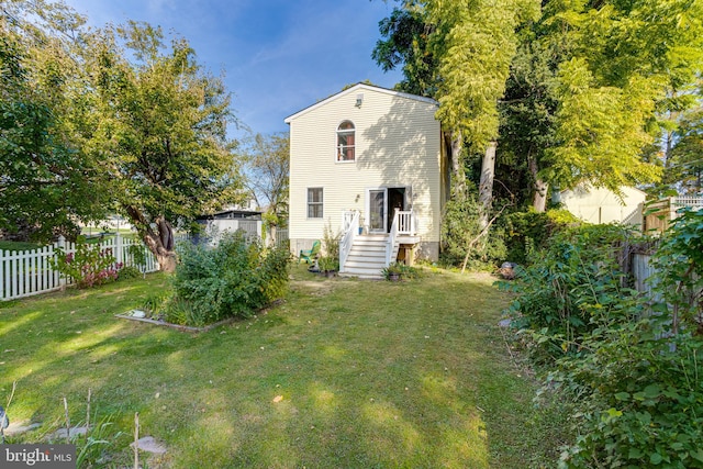 rear view of house with a lawn