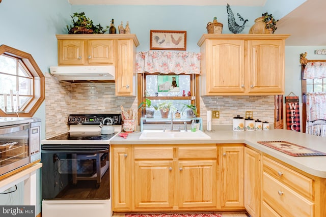 kitchen with light brown cabinetry, plenty of natural light, white electric stove, and sink