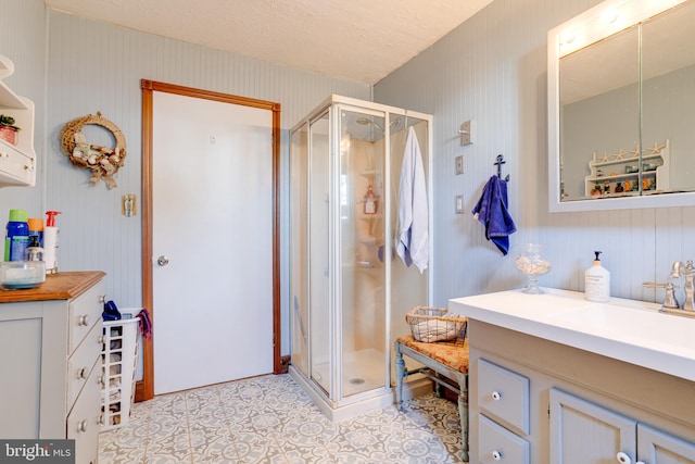 bathroom featuring walk in shower and vanity