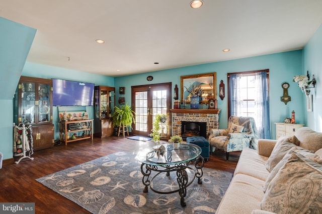 living room featuring a fireplace, dark hardwood / wood-style floors, and french doors