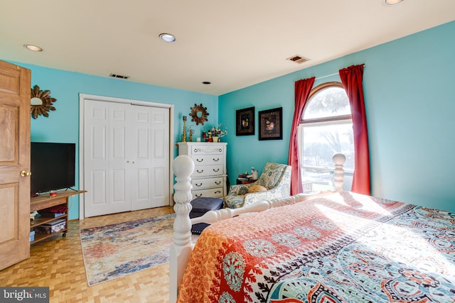 bedroom with a closet and light parquet floors