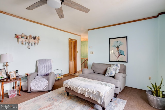 living room featuring ceiling fan, ornamental molding, and carpet floors