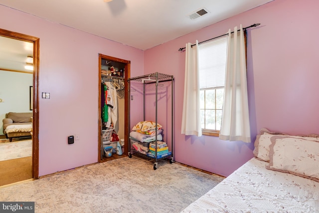 bedroom with light colored carpet and a closet