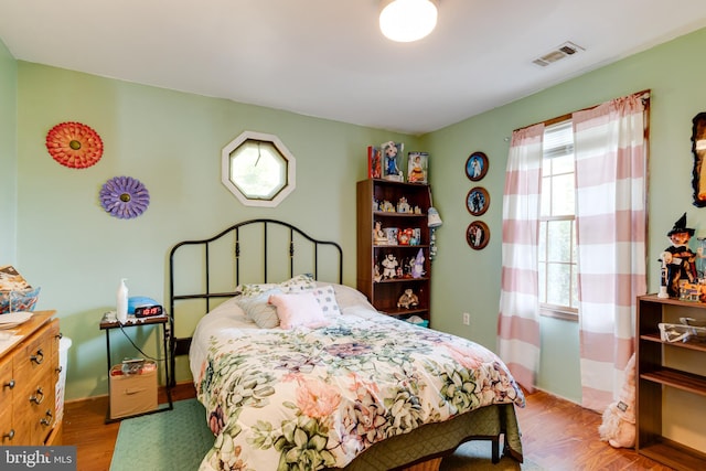 bedroom with hardwood / wood-style flooring