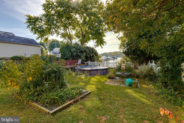 view of yard with a fenced in pool