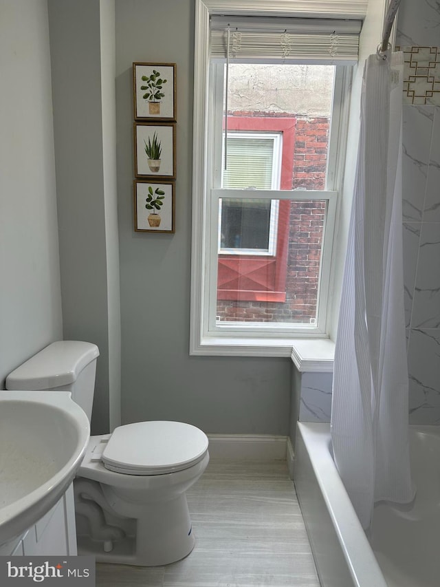 full bathroom featuring toilet, vanity, and shower / bathtub combination with curtain