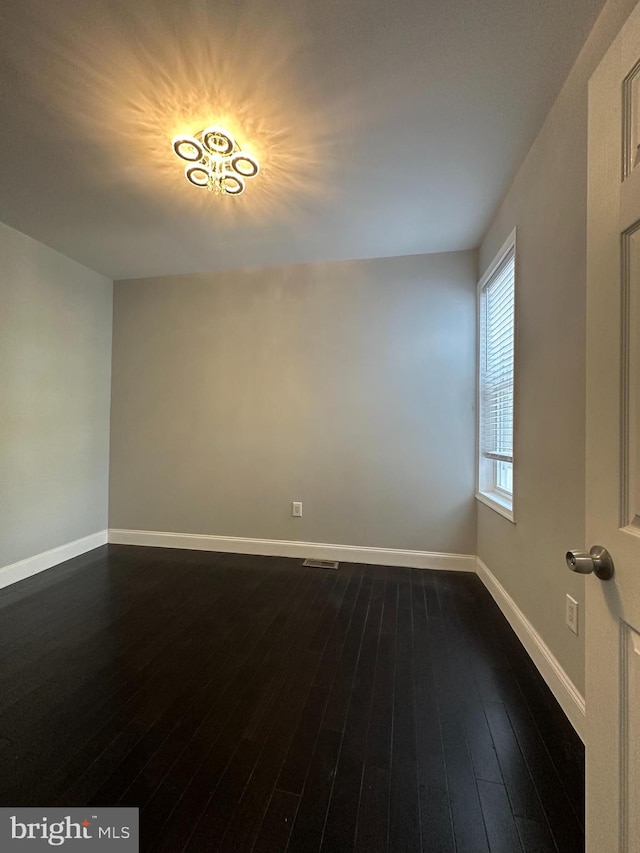 spare room featuring dark hardwood / wood-style flooring