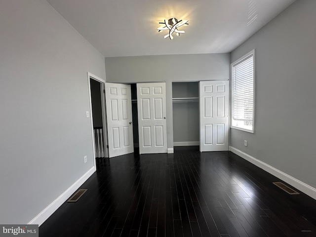 unfurnished bedroom featuring dark wood-type flooring