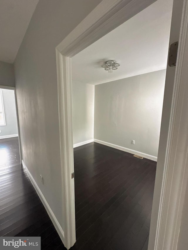 corridor with dark hardwood / wood-style floors