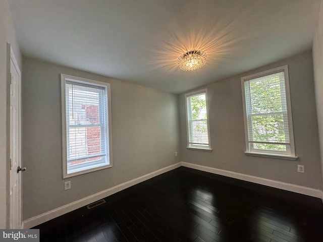 spare room with hardwood / wood-style floors and a wealth of natural light